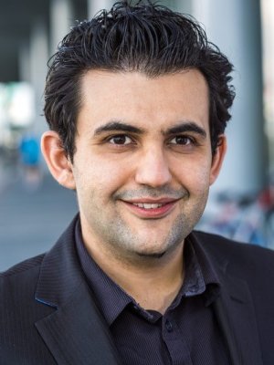 Head shot of a man in a black suit.